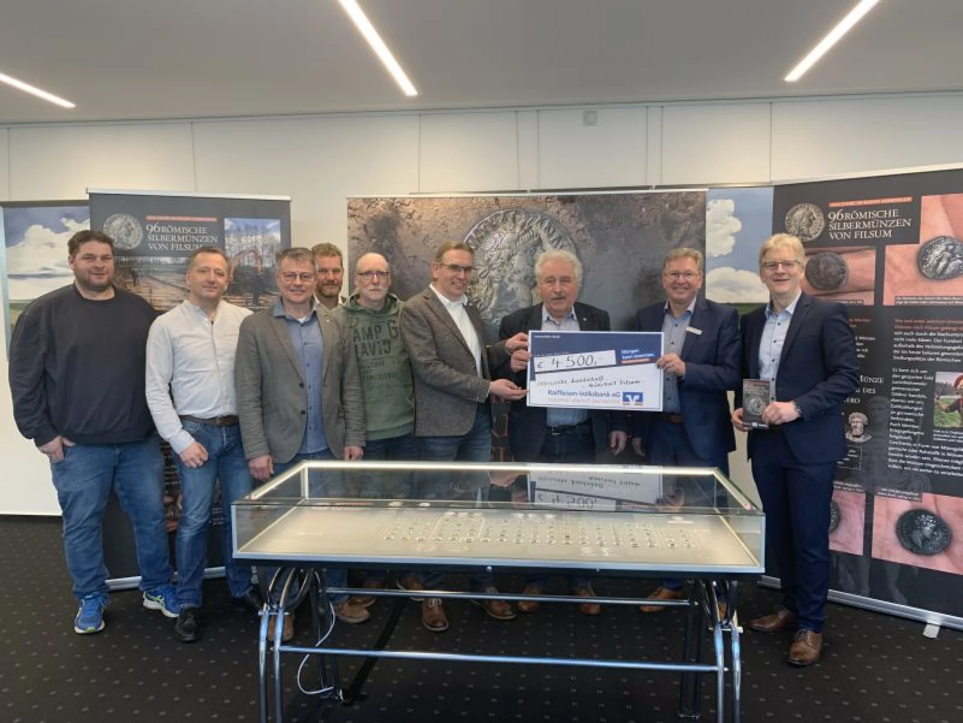 Das RVB-Vorstandsmitglied Mario Baumert (v.r.) und RVB-Regionaldirektor Carl-Heinz Kloppenburg präsentierten zusammen mit dem Landschaftspräsidenten Rico Mecklenburg, dem Leiter des archäologischen Forschungsinstituts der Ostfriesischen Landschaft, Dr. Jan Kegler, sowie den Sondengängern Herbert Albrecht, Carsten Eilts, Sebastian Heibült, Wolfgang Janßen und Thomas Schlunck die Exponate bei der Ausstellungseröffnung im März.